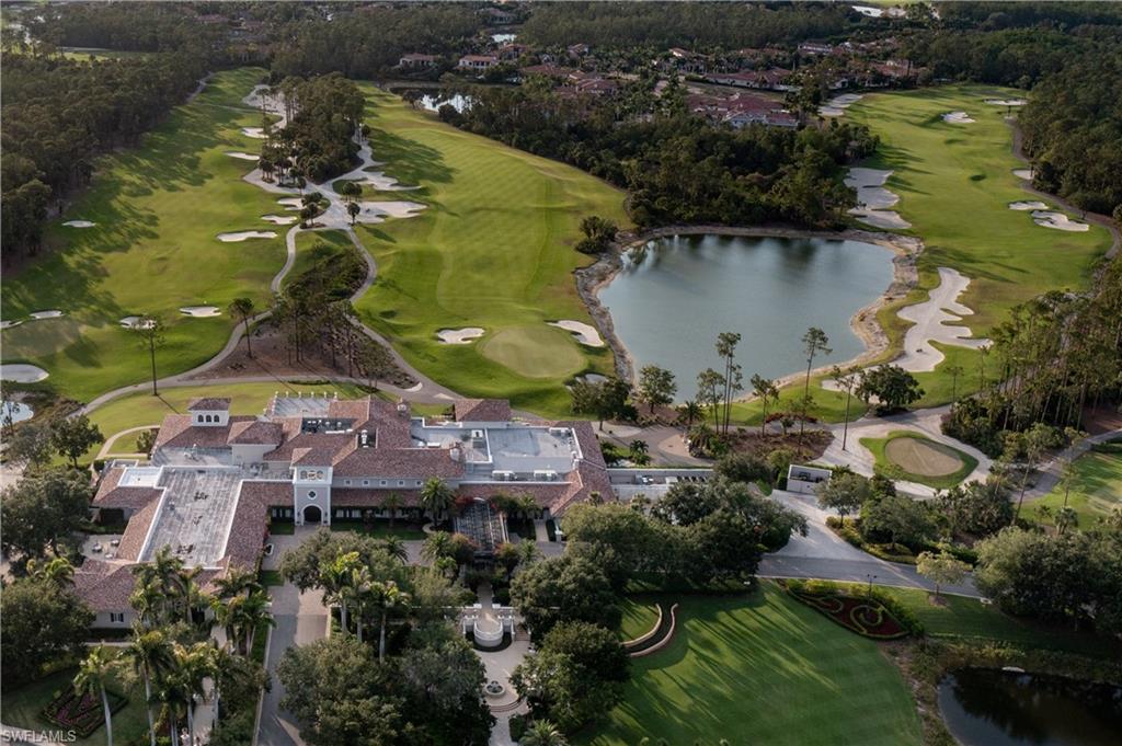 15532 Monterosso Lane, Unit 102 Naples, FL 34110 - Photo 45 of 49 an aerial view of a house with a yard and lake view