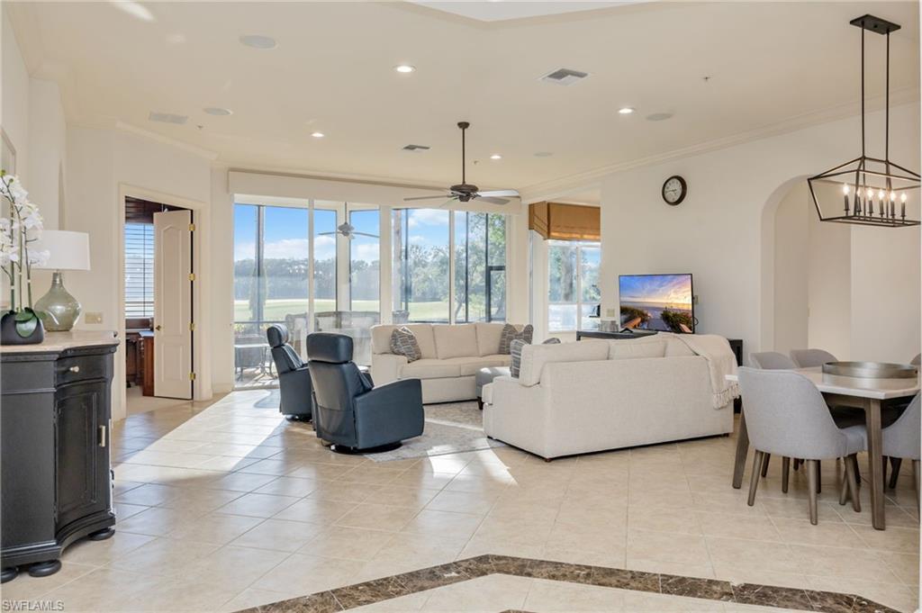 15532 Monterosso Lane, Unit 102 Naples, FL 34110 - Photo 10 of 49 a living room with furniture and large windows
