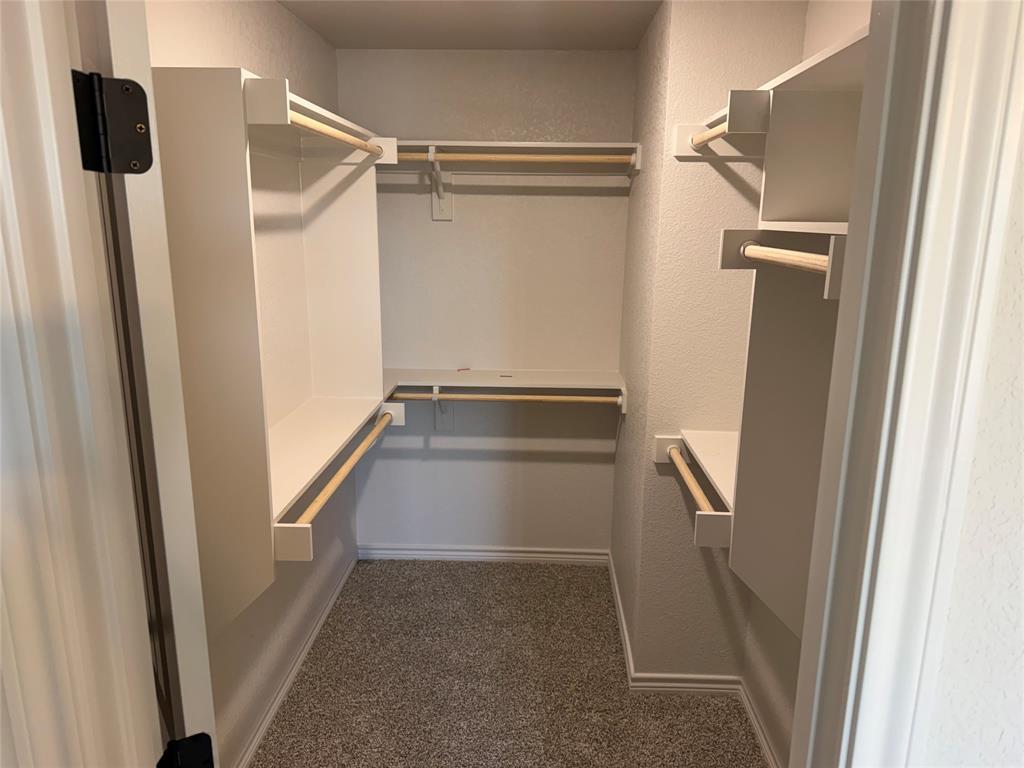 2998 Knob Road Springtown, TX 76082 - Photo 5 of 7 a view of walk in closet with empty racks