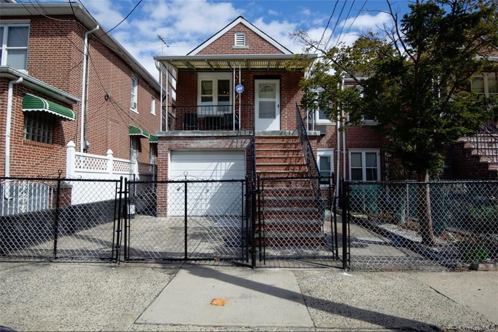 a front view of a house with iron fence