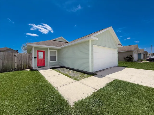 a view of a house with a yard and garage