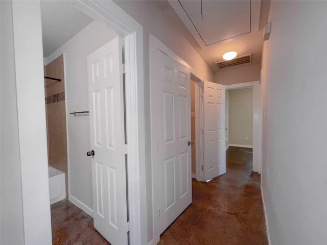 a view of a hallway with a wooden door