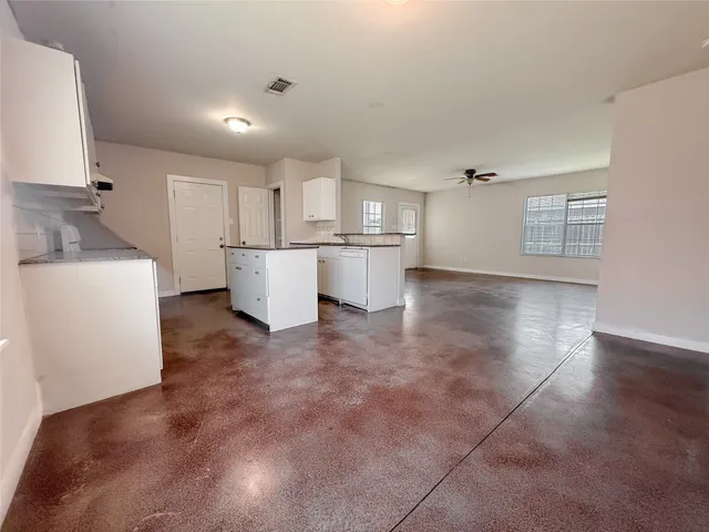 a kitchen with a sink and a stove top oven