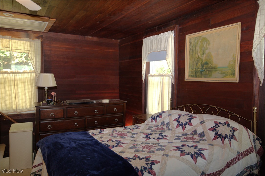 22760 Roy Croy Road Senecaville, OH 43780 - Photo 24 of 46 Bedroom featuring wooden walls and wooden ceiling