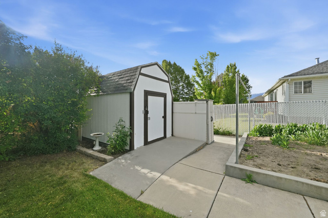 1464 990 West Provo, UT 84601 - Photo 39 of 41 Utility shed with gambrel roof, white siding, and dark trim