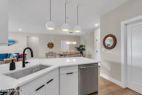 22 Cooper Avenue, Unit 202 Long Branch, NJ 07740 - Photo 11 of 38 a kitchen with a sink a counter and a dining table with wooden floor
