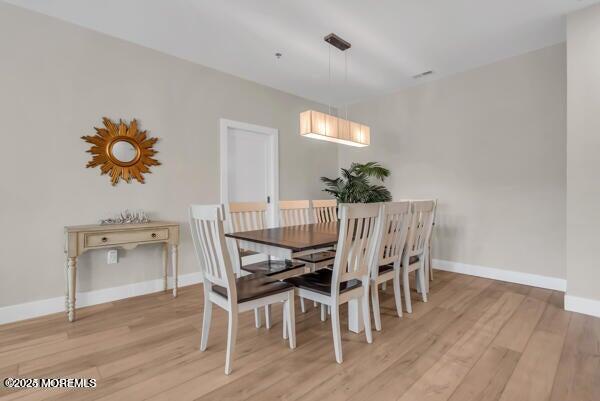 22 Cooper Avenue, Unit 202 Long Branch, NJ 07740 - Photo 12 of 38 a view of a dining room with furniture and wooden floor