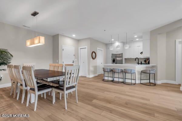 22 Cooper Avenue, Unit 202 Long Branch, NJ 07740 - Photo 14 of 38 a view of a dining room with furniture and wooden floor