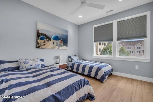22 Cooper Avenue, Unit 202 Long Branch, NJ 07740 - Photo 21 of 38 a bedroom with two beds and a large window