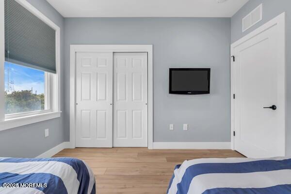 22 Cooper Avenue, Unit 202 Long Branch, NJ 07740 - Photo 22 of 38 a bedroom with a bed and flat screen tv