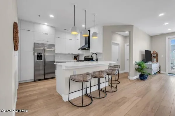 a kitchen with stainless steel appliances granite countertop a stove a refrigerator and a sink