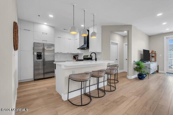 22 Cooper Avenue, Unit 202 Long Branch, NJ 07740 - Photo 8 of 38 a kitchen with stainless steel appliances kitchen island granite countertop a stove a refrigerator and a wooden floor