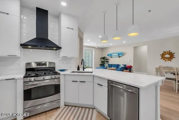 a kitchen with a sink a counter and a dining table with wooden floor