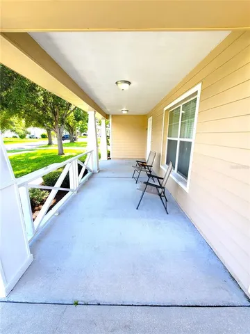 a view of a patio with a table and chairs