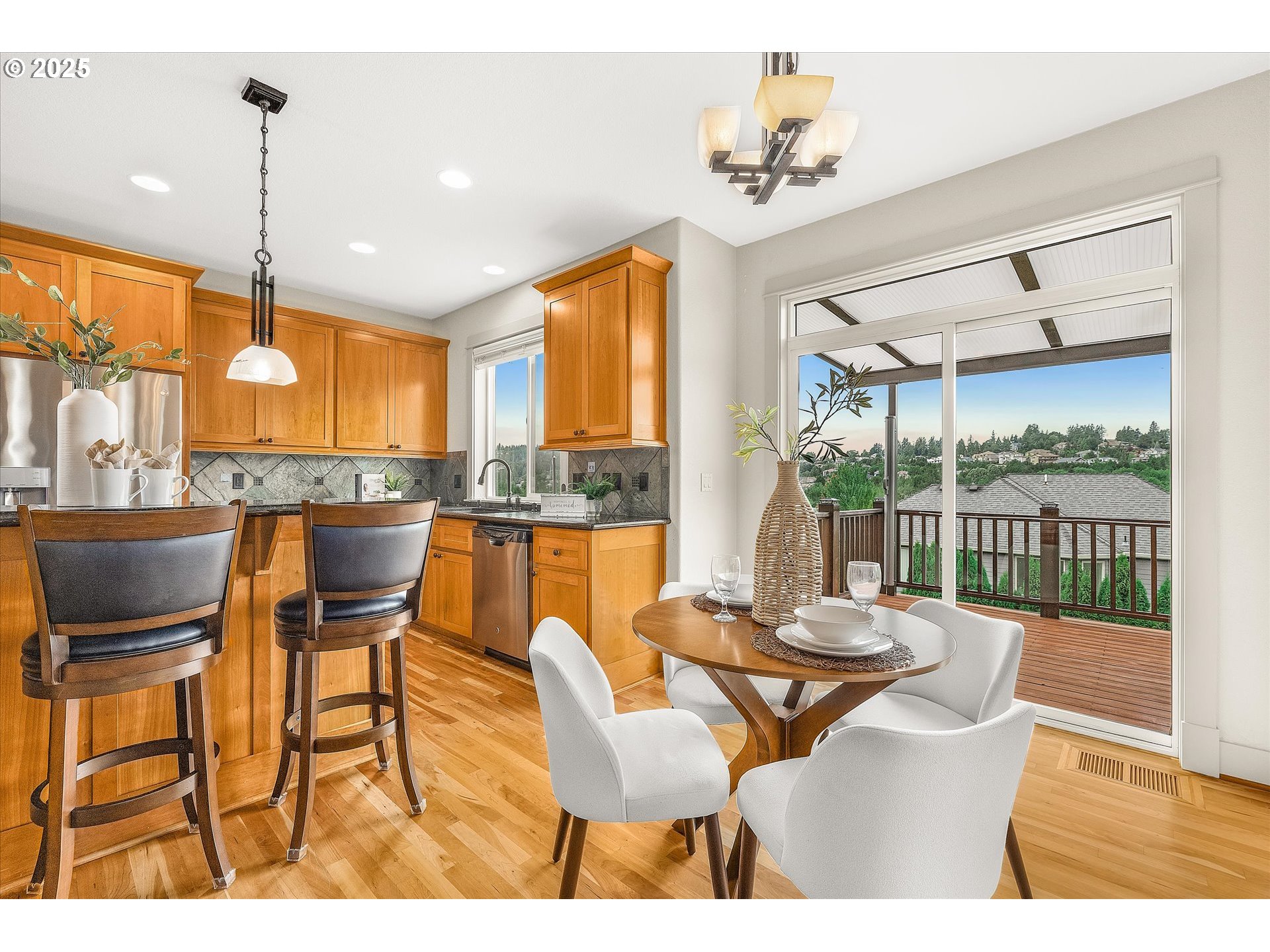 14697 Southeast Poppy Hills Drive Happy Valley, OR 97086 - Photo 11 of 48 a dining room with furniture a chandelier and wooden floor