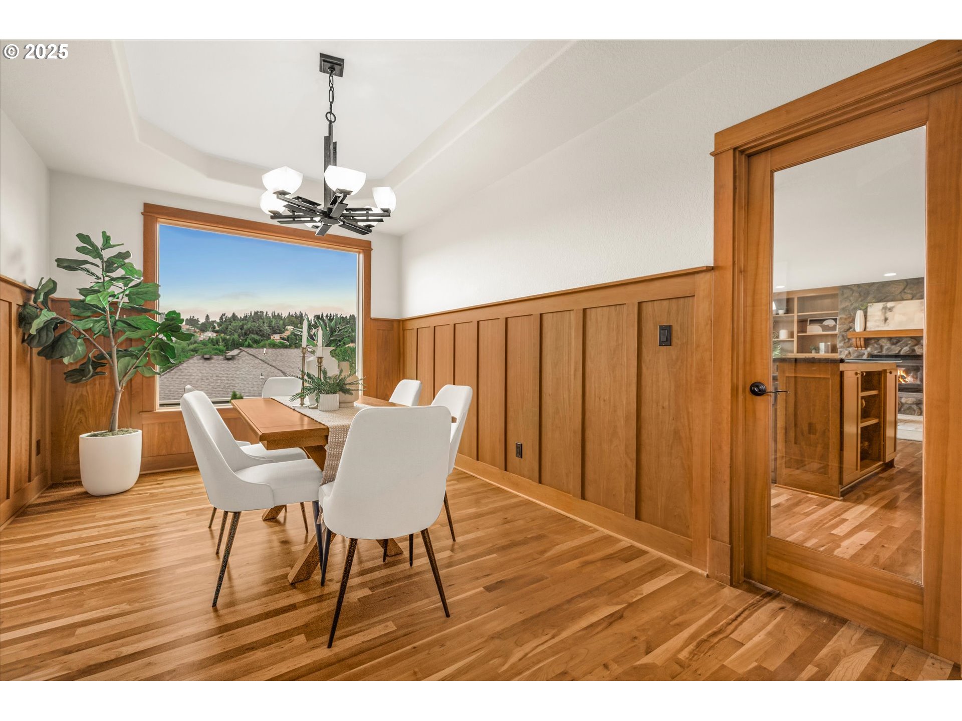 14697 Southeast Poppy Hills Drive Happy Valley, OR 97086 - Photo 18 of 48 a view of a dining room with furniture wooden floor and chandelier