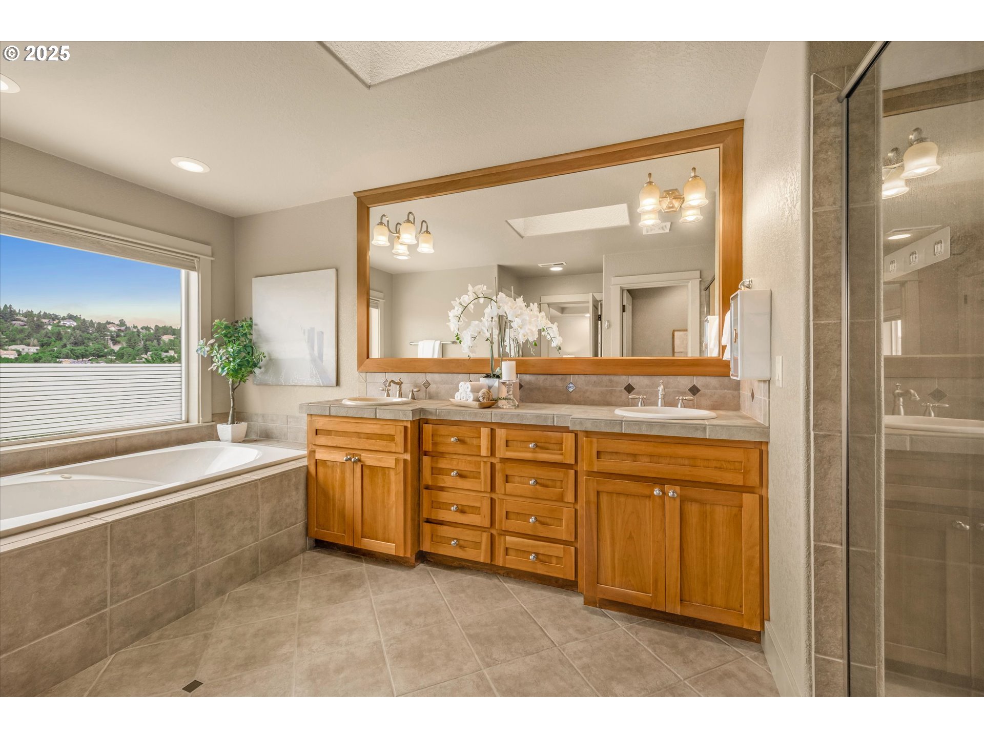 14697 Southeast Poppy Hills Drive Happy Valley, OR 97086 - Photo 23 of 48 a bathroom with a granite countertop sink mirror and a bathtub