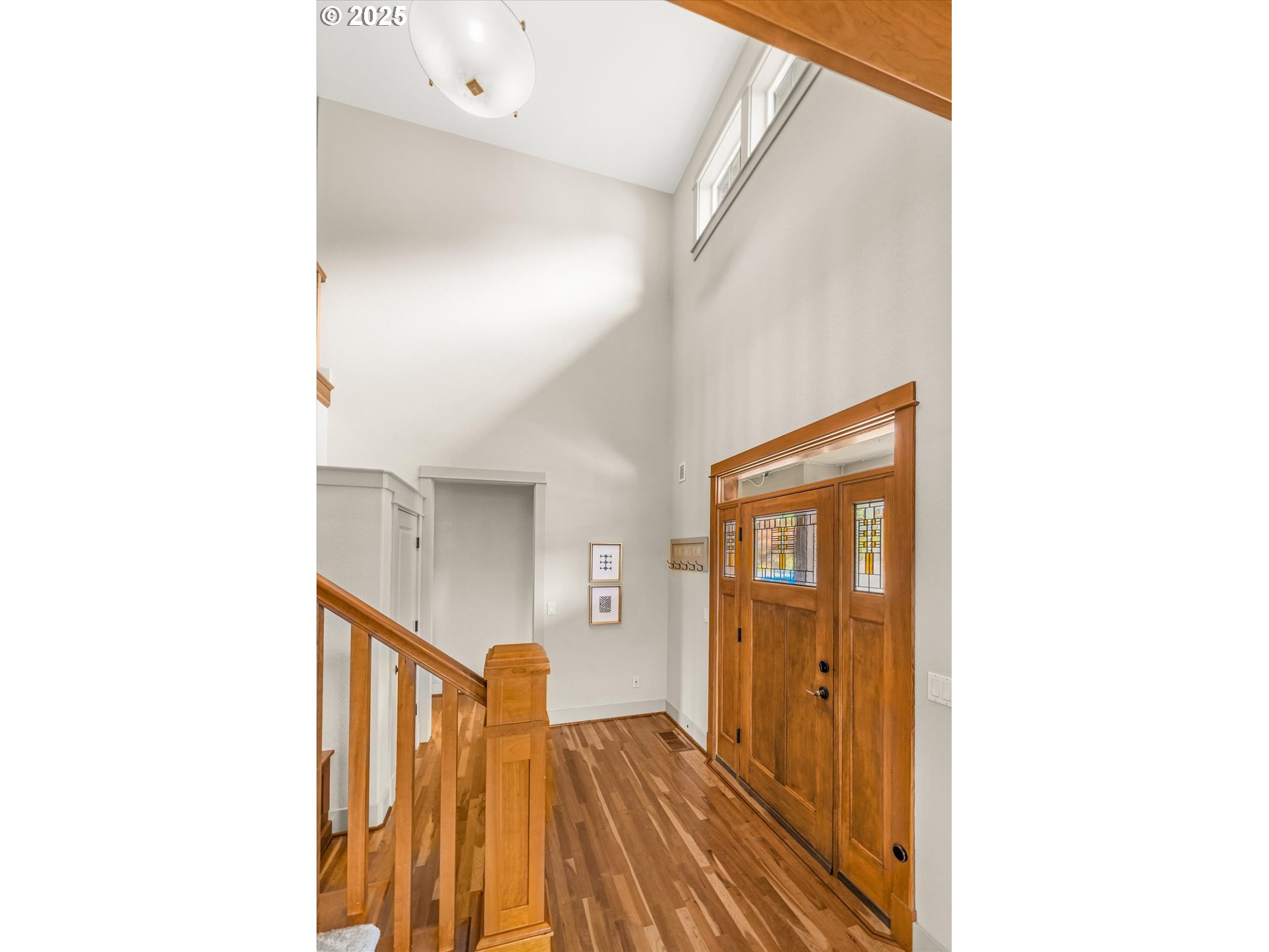 14697 Southeast Poppy Hills Drive Happy Valley, OR 97086 - Photo 3 of 48 a view of a hallway with wooden floor