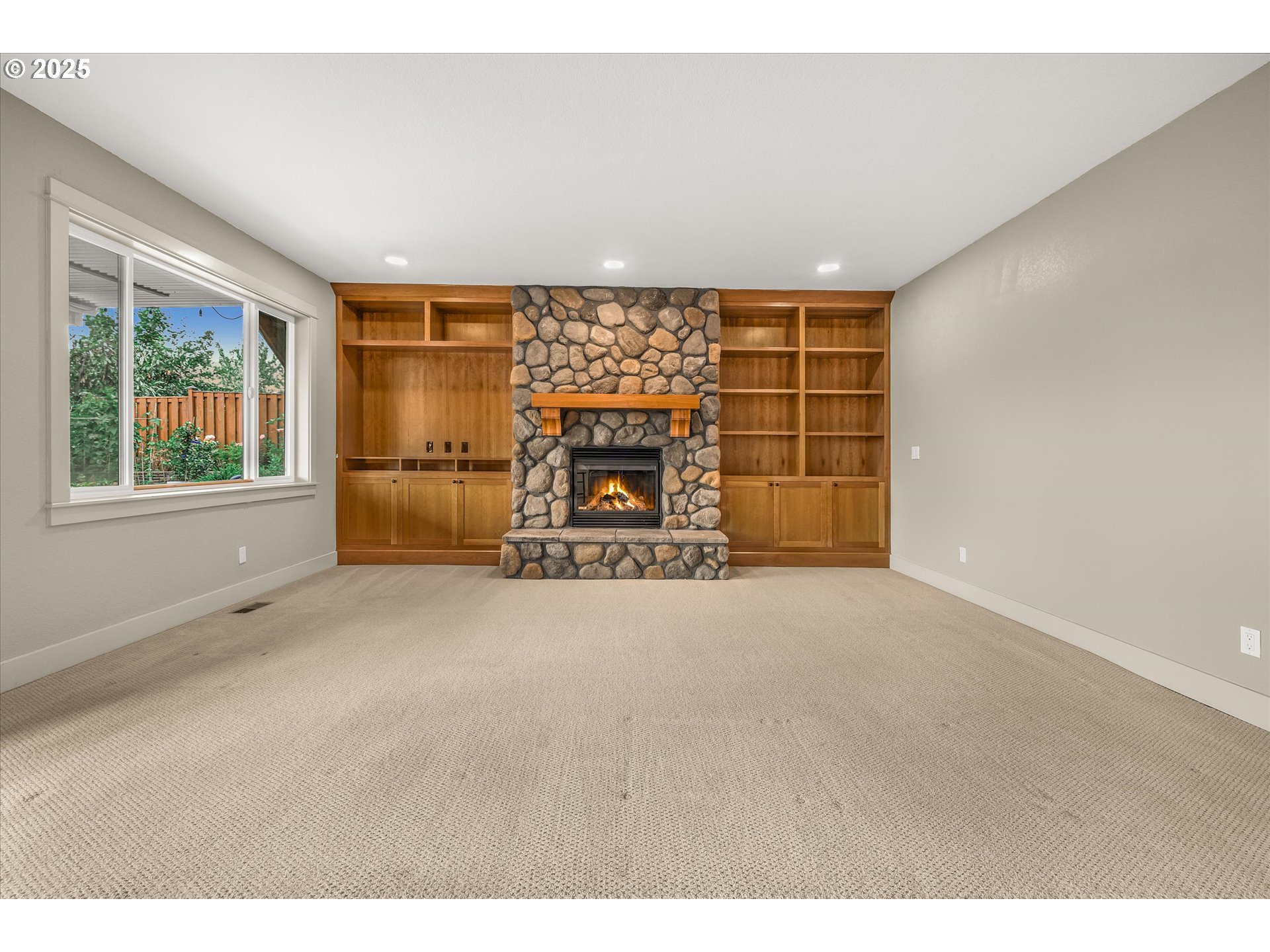 14697 Southeast Poppy Hills Drive Happy Valley, OR 97086 - Photo 33 of 48 a view of an empty room with a window and a fireplace