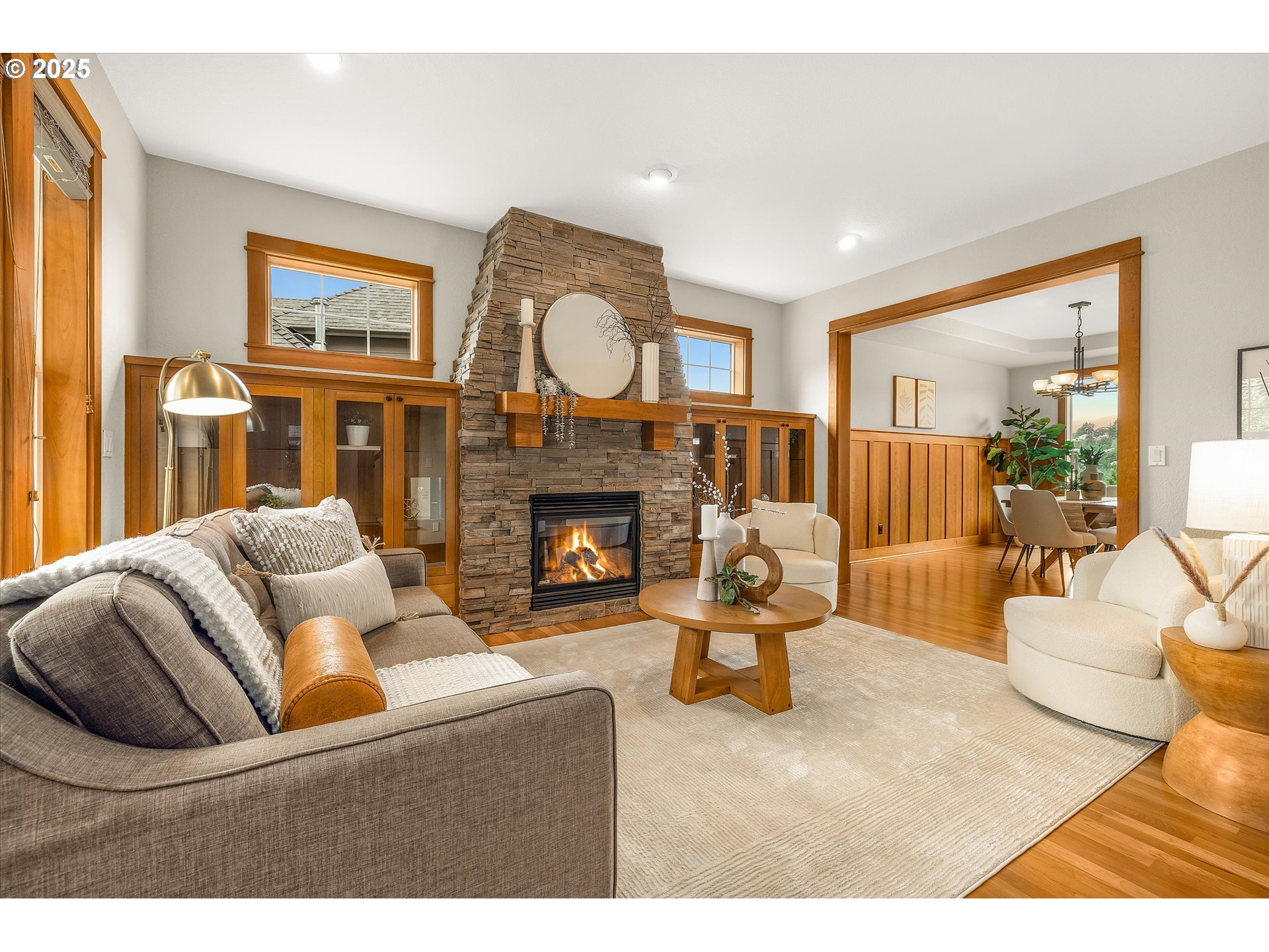 14697 Southeast Poppy Hills Drive Happy Valley, OR 97086 - Photo 4 of 48 a living room with furniture a fireplace and a large window