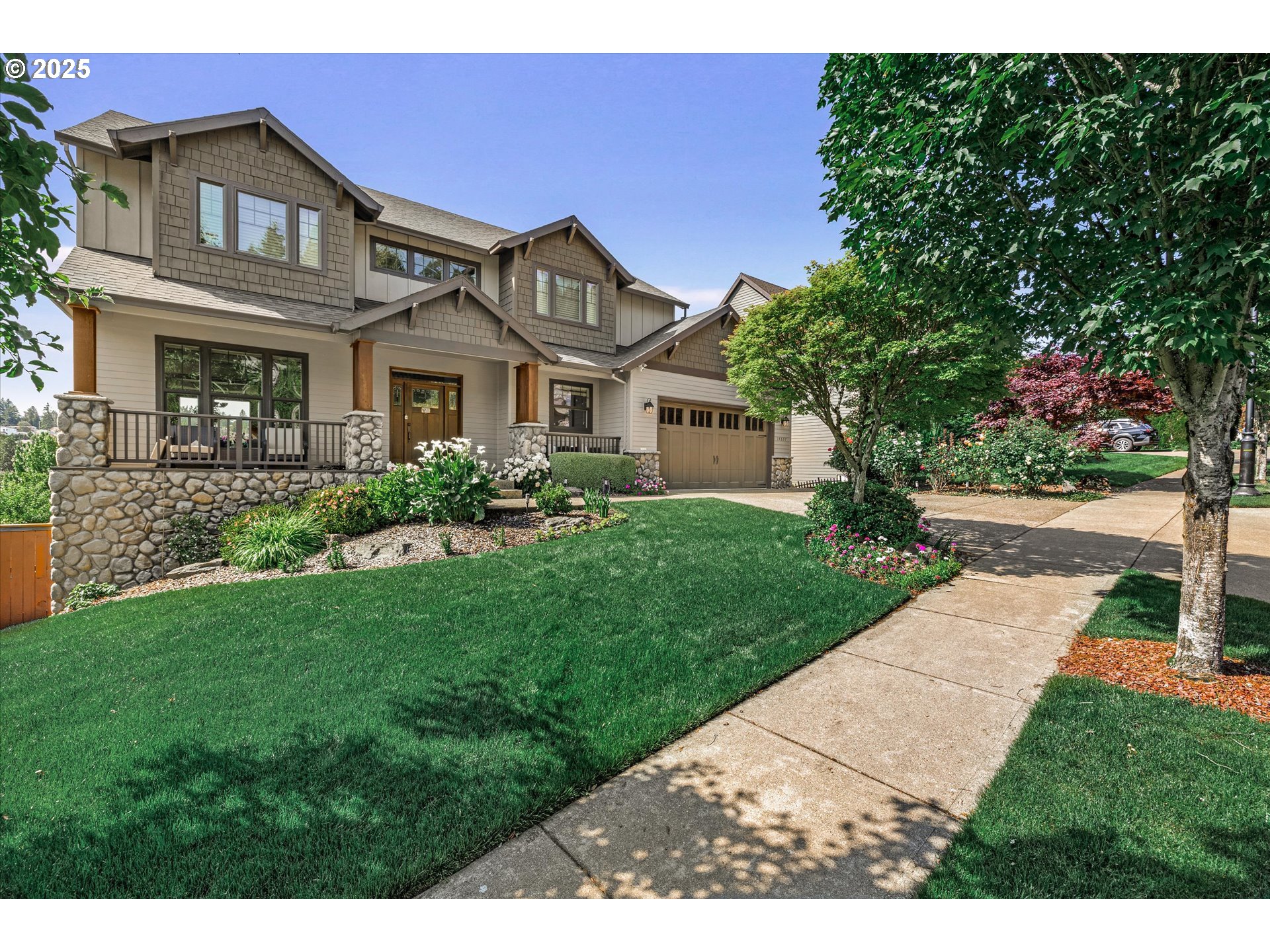 14697 Southeast Poppy Hills Drive Happy Valley, OR 97086 - Photo 48 of 48 a front view of a house with a garden and plants
