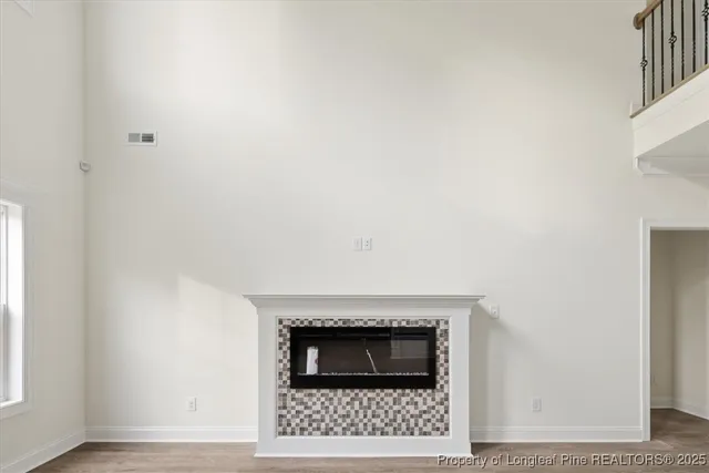 a living room with a fireplace and a ceiling fan