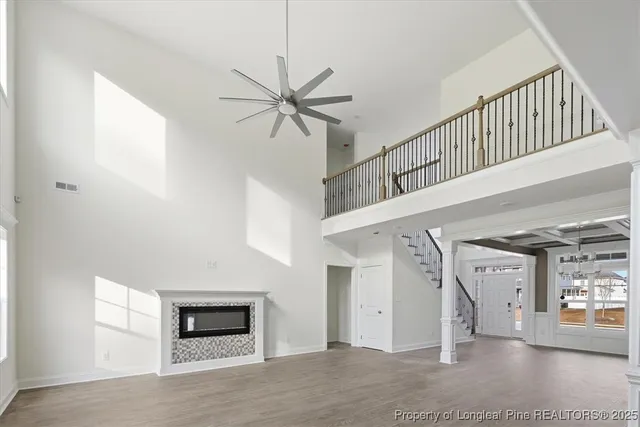 a view of a livingroom with wooden floor and a ceiling fan