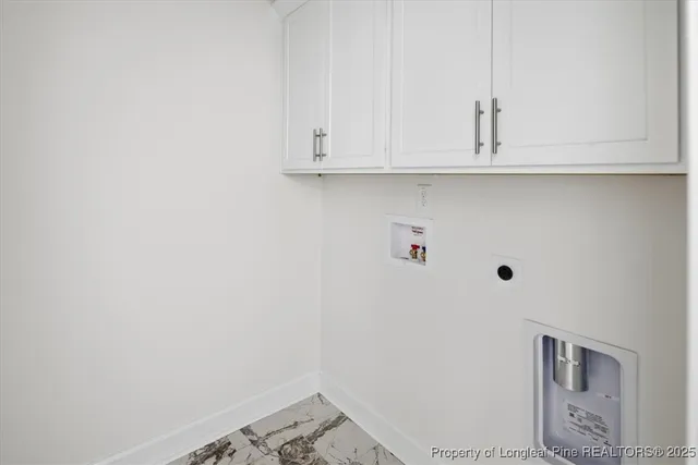 an empty room with windows and ceiling fan