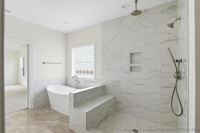 a view of staircase with lots of frames on wall and windows