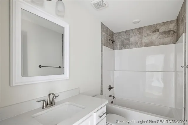 a view of a kitchen with white cabinets