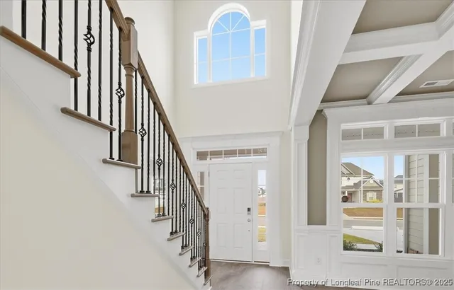 a view of staircase with wooden floor and door