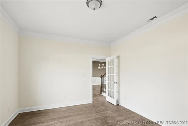 a view of empty room with wooden floor