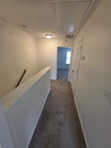 a view of a hallway with stairs