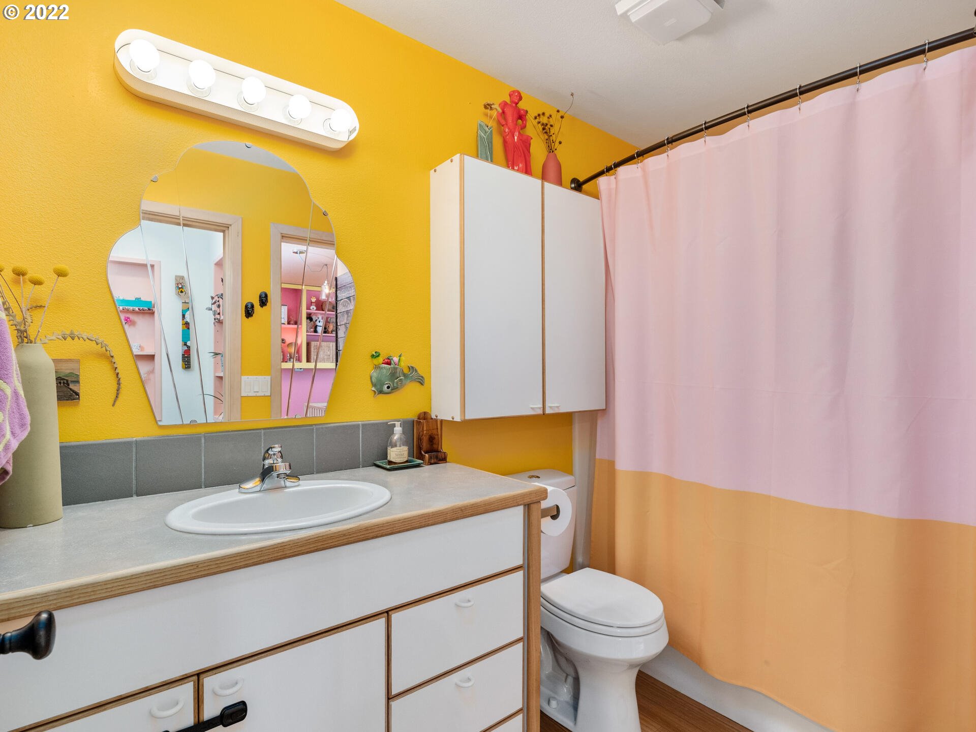 17617 Northwest Sauvie Island Road, Unit 39 Portland, OR 97231 - Photo 15 of 32 a bathroom with a sink a toilet and a mirror