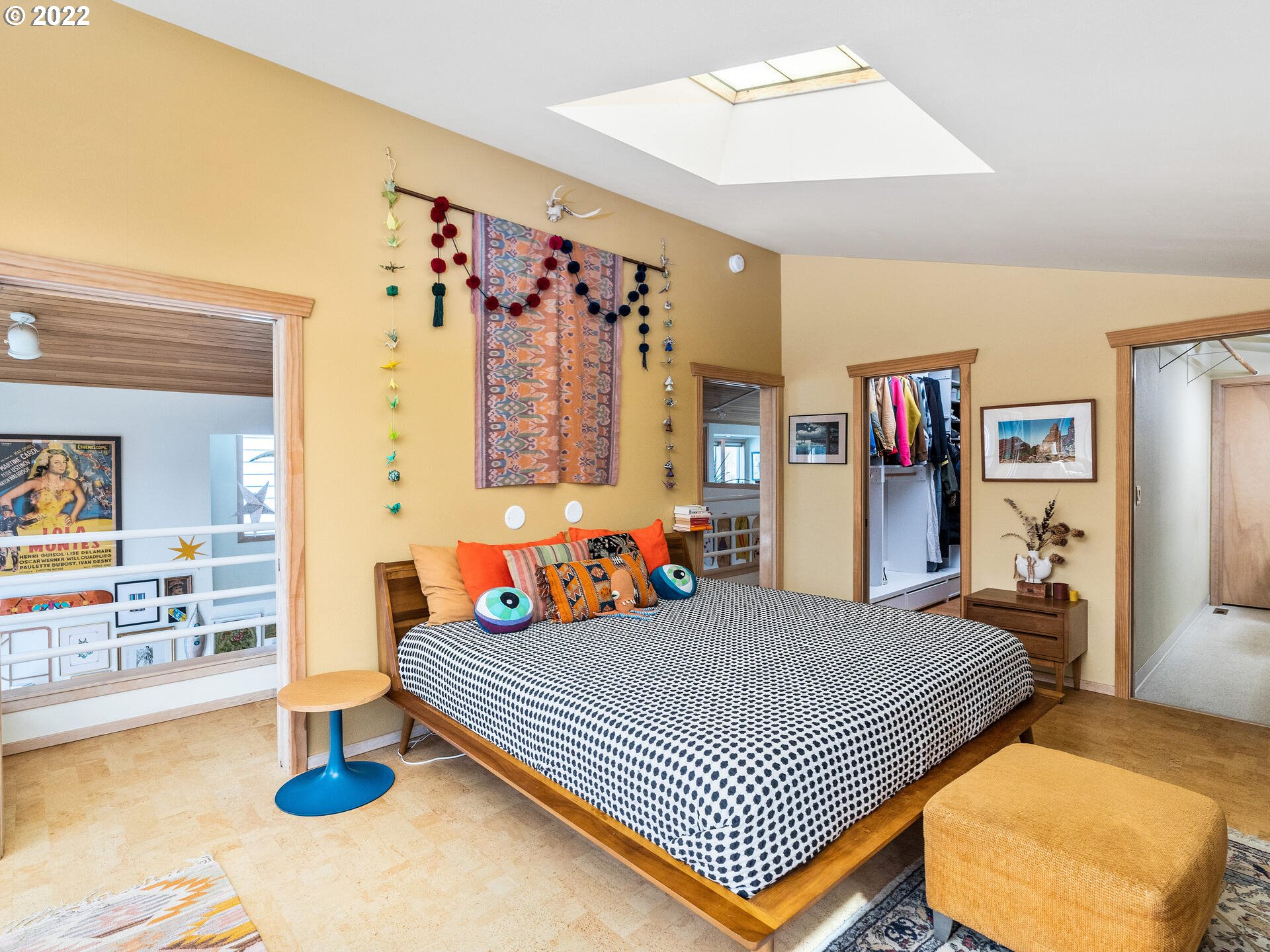 17617 Northwest Sauvie Island Road, Unit 39 Portland, OR 97231 - Photo 20 of 32 a bedroom with a bed and wall paintings