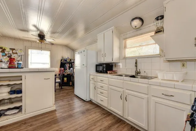 a bedroom with bed and a flat tv screen on dresser