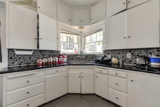 a kitchen with stainless steel appliances a stove a sink and a cabinets