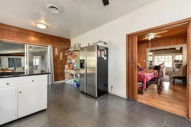 a view of a chair and table in backyard of the house
