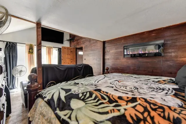 an aerial view of residential houses with outdoor space and trees