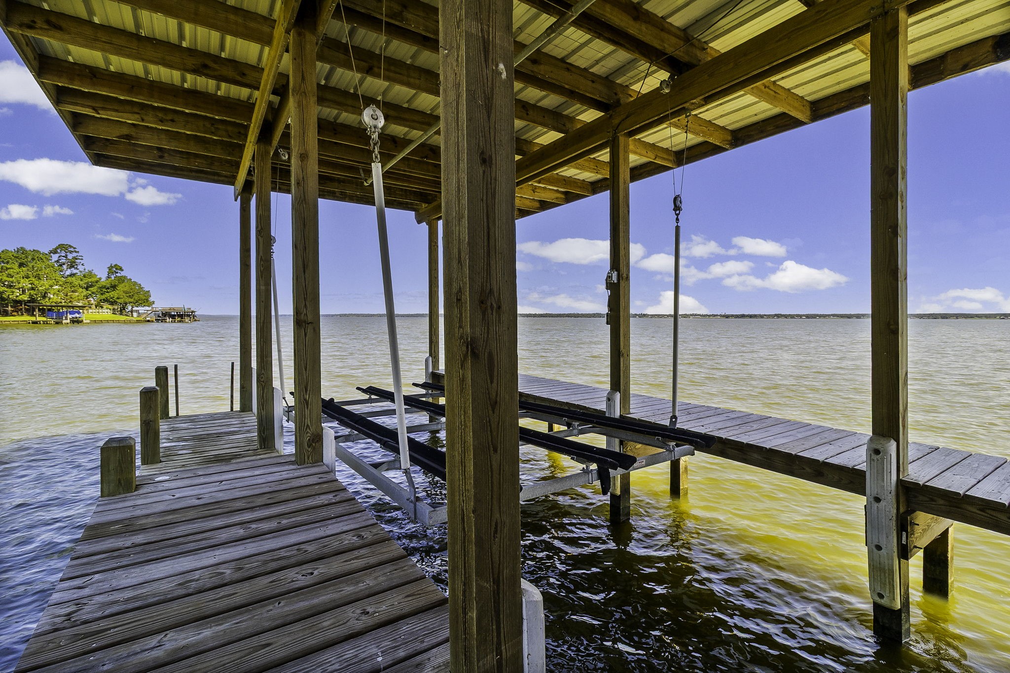 151 Key Largo Loop Point Blank, TX 77364 - Photo 38 of 49 Covered boat slip with boat lift, providing protected storage and convenient access to open-water boating.