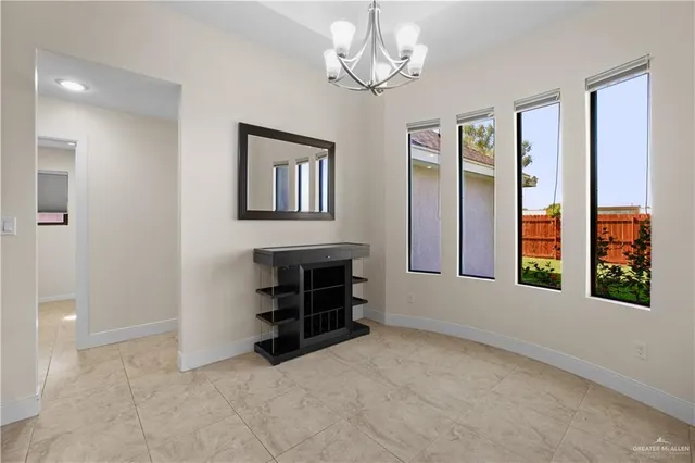 an empty room with closet and a chandelier fan