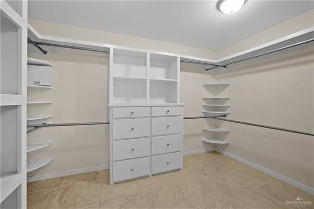 a bathroom with a sink a mirror a vanity and a shower