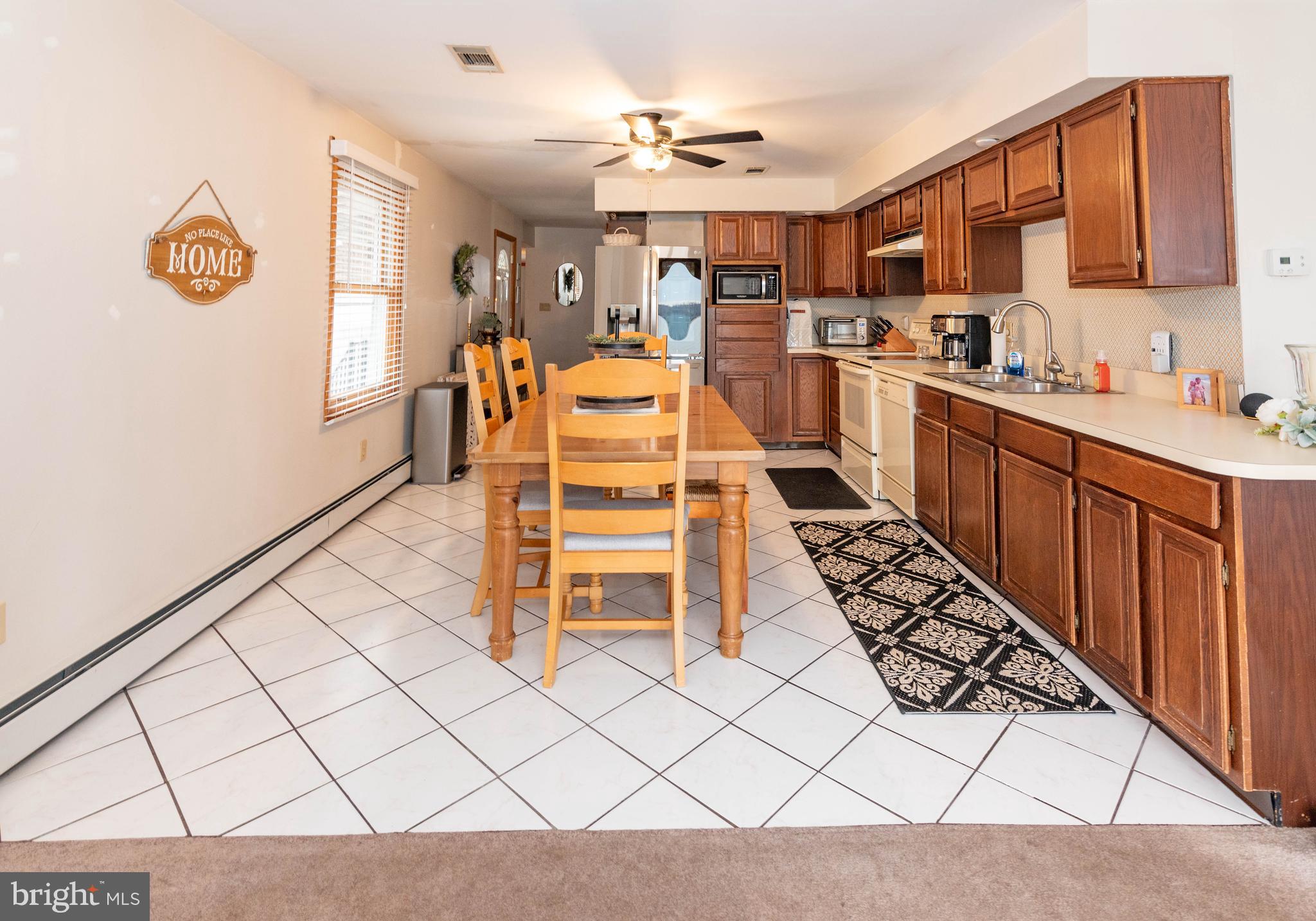 7316 Greenbank Road Baltimore, MD 21220 - Photo 16 of 87 a kitchen with stainless steel appliances a stove a sink cabinets and a counter top space