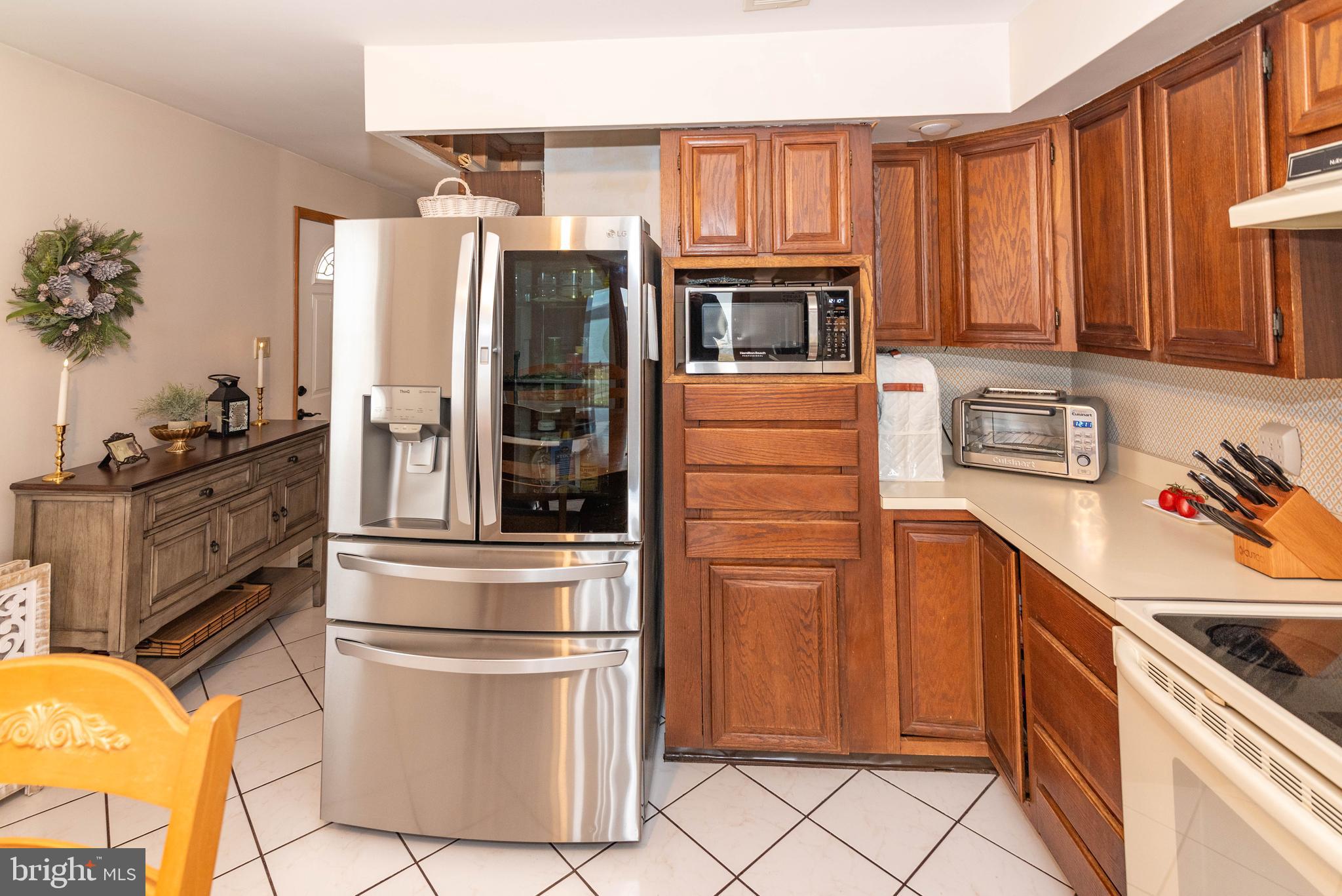 7316 Greenbank Road Baltimore, MD 21220 - Photo 19 of 87 a kitchen with stainless steel appliances granite countertop a refrigerator sink and stove