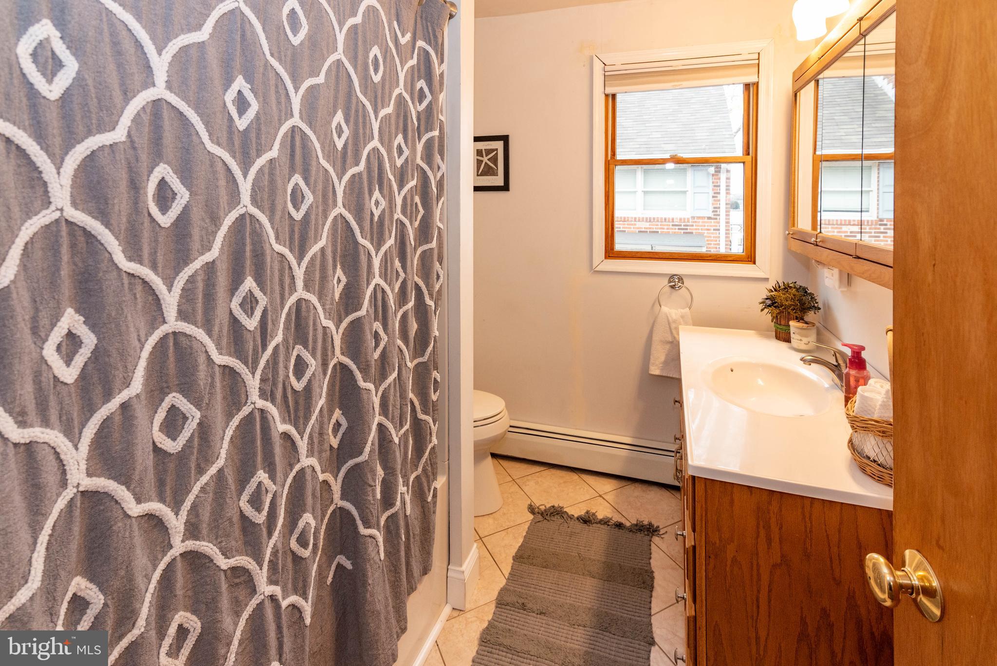 7316 Greenbank Road Baltimore, MD 21220 - Photo 22 of 87 a bathroom with a bathtub and a shower curtain