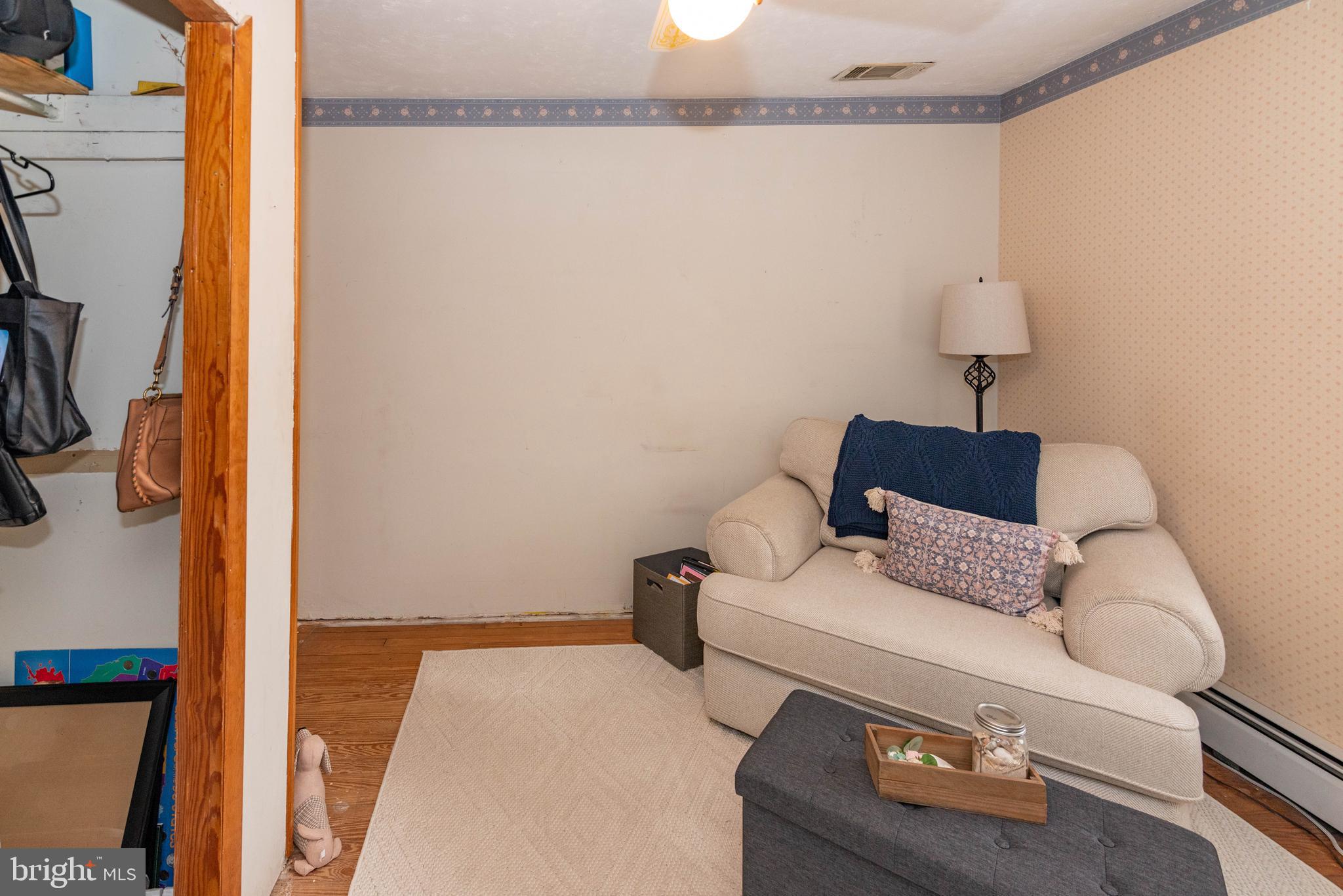 7316 Greenbank Road Baltimore, MD 21220 - Photo 25 of 87 a living room with furniture and a rug