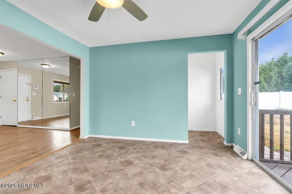 an empty room with wooden floor and traffic signal
