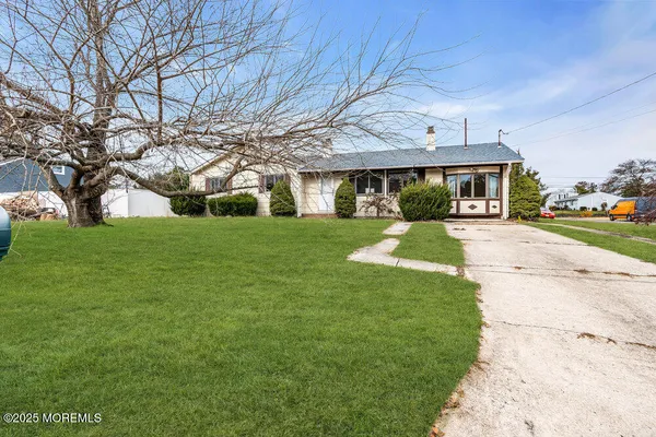 a front view of house with yard and green space