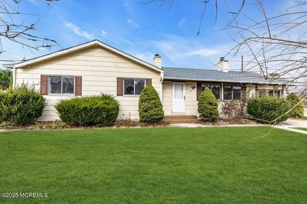 a front view of house with yard and green space