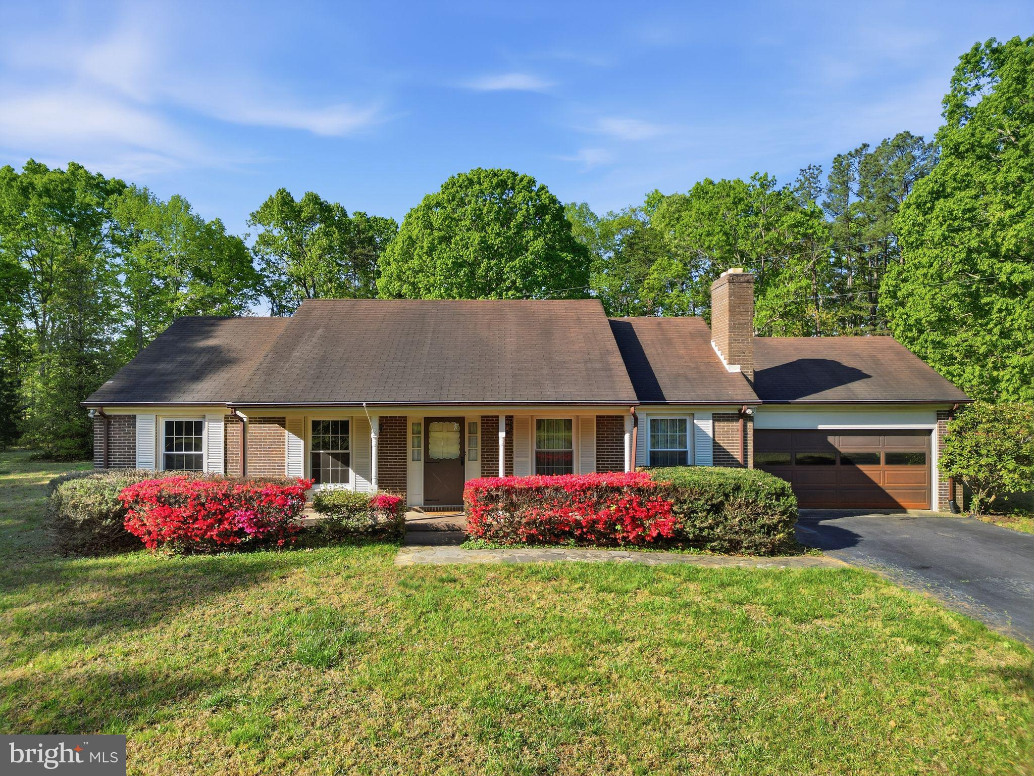 Charming home with vibrant landscaping.